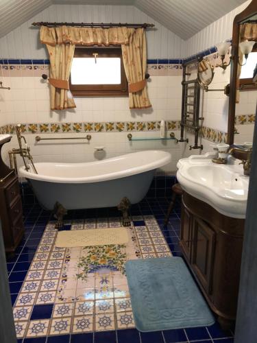 a bathroom with a tub and a sink at Villa Anna in Guta