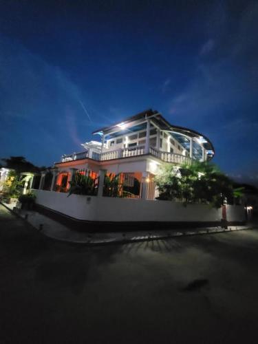a large house with lights on top of it at night at Luxury Posada inn in Los Amates