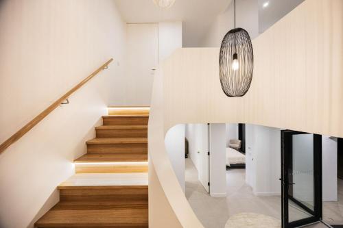 a staircase in a house with a pendant light at Grandview Lookout - McCrae in McCrae