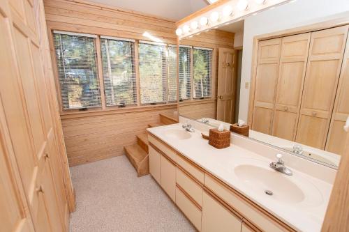 a bathroom with a sink and a mirror at Soundside-Resort Amenities, Comm Pool-322, Out of Bounds in Corolla