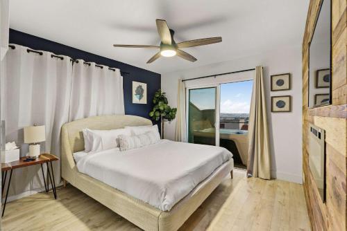 a bedroom with a bed and a ceiling fan at The California - On Top of San Diego in a Hot Tub in San Diego