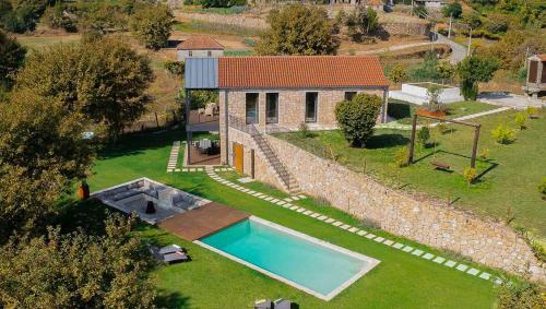an aerial view of a house with a swimming pool at Quinta da Lameirinha Douro, Boutique Home - Heated Pool and Jacuzzi in Baião