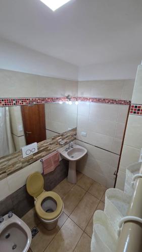 y baño con lavabo, aseo y bidet. en Dpto a pasos de la peatonal, en Villa Carlos Paz