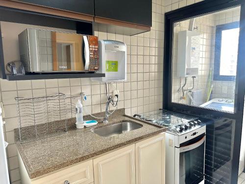 a kitchen with a sink and a counter top at Flat luxo, Janela Antirruído, Garagem, serviços in São Paulo