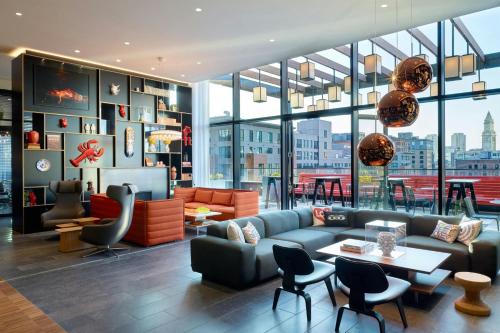a living room with a couch and a table at citizenM Boston North Station in Boston