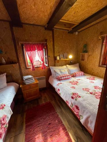 a bedroom with two beds and a window at Vikendica RANKOVIĆI in Mokra Gora