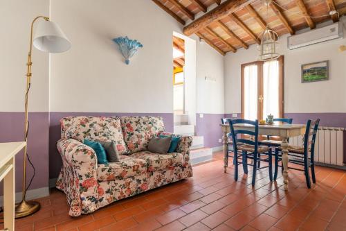 a living room with a couch and a table at Fabio Apartments San Gimignano in San Gimignano