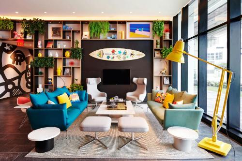 a living room with colorful furniture and a tv at citizenM Miami World Center in Miami