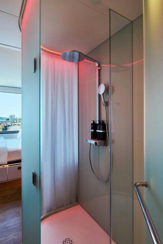 a bathroom with a shower with a glass door at citizenM Boston Back Bay in Boston