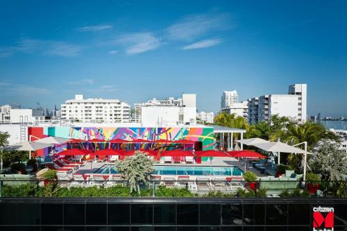 a colorful building with a pool in front of a city at citizenM Miami South Beach in Miami Beach