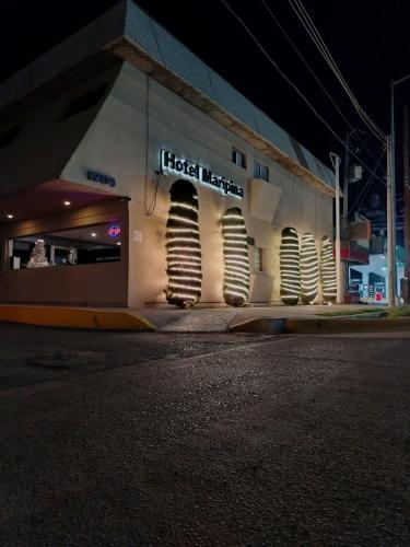 a building with a sign on the side of a street at HOTEL MARIPINA in Ciudad Juárez