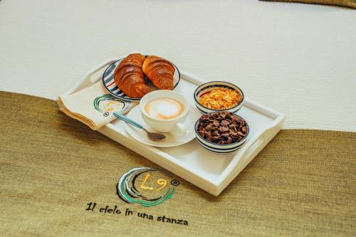 un vassoio di cibo con pasticcini e caffè su un tavolo di Ellenove holiday house a Tortoreto