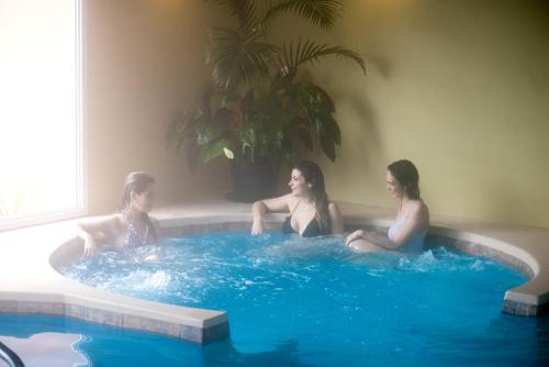 three women are sitting in a hot tub at Don Numas Posada & Spa in San Lorenzo