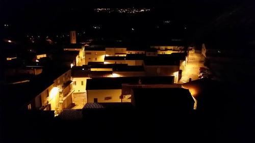 a view of a city at night with buildings at B&B La Tasgia in Aggius