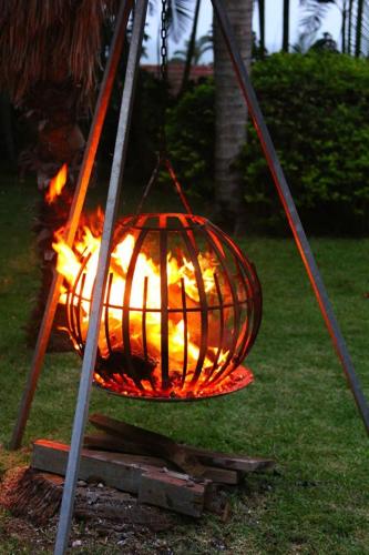 a fire in a cage hanging from a chain at Hunters B&B in Mtunzini