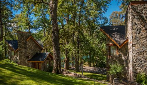 a house in the woods with trees at Paihuen - Resort De Montaña in San Martín de los Andes