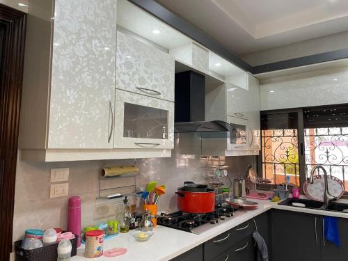 a kitchen with a stove and a counter top at عمارة زكي الرمحي 6 in Amman