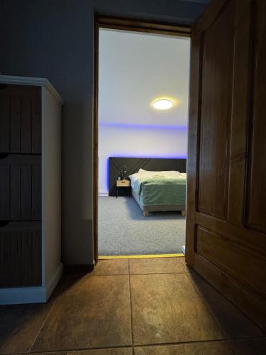 an open door to a bedroom with a bed at House in the Heart of Râșnov Old Town in Râşnov