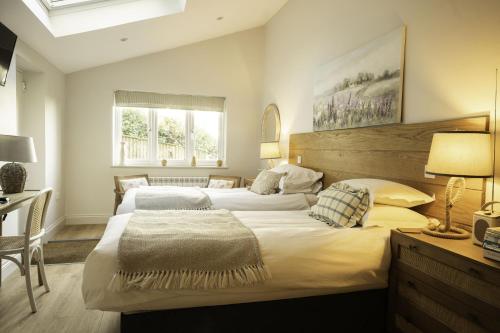 a bedroom with two beds and a table and a desk at Winyard's Gap Inn in South Perrott