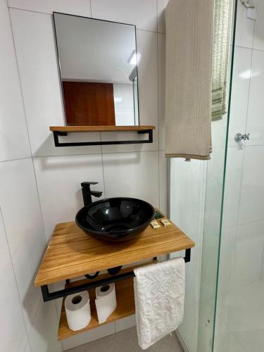 a bathroom with a black sink and a mirror at Casa em Cajamar - Polvilho, 10 minutos de Jordanésia in Cajamar