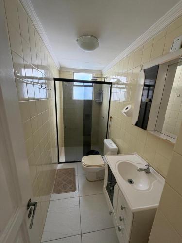 a bathroom with a shower and a toilet and a sink at Spacious & Artistic Apartment in Belém in Belém