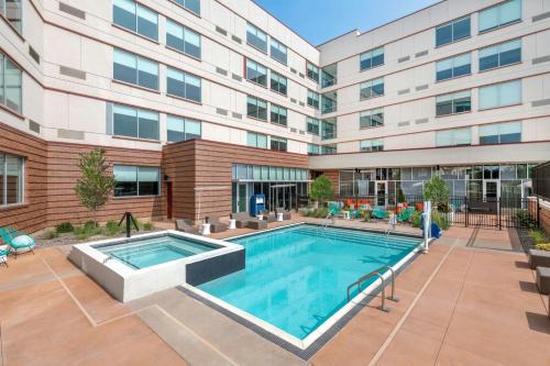 a swimming pool in front of a building at Aloft Denver North Westminster in Westminster