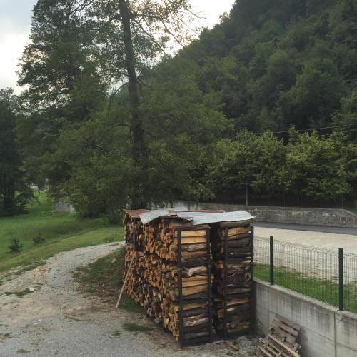 a pile of fire wood sitting next to a road at B&B La Ceramica Moline in Vicoforte