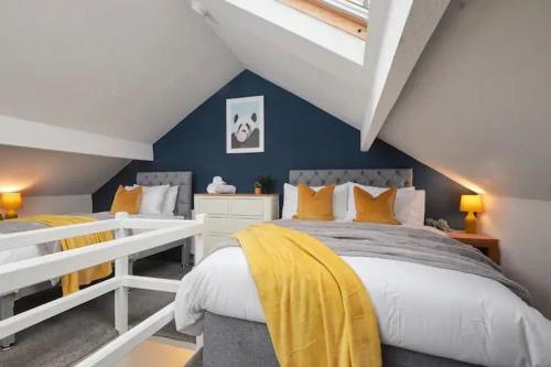 a attic bedroom with a bed and a couch at The Bluebird Rooms II in Headingley
