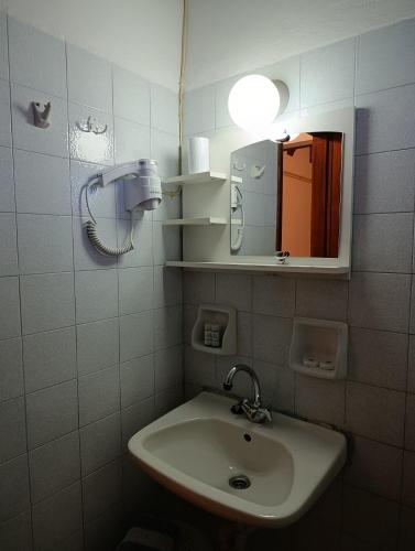 a bathroom with a sink and a mirror at Villa Horizon in Tsagarada