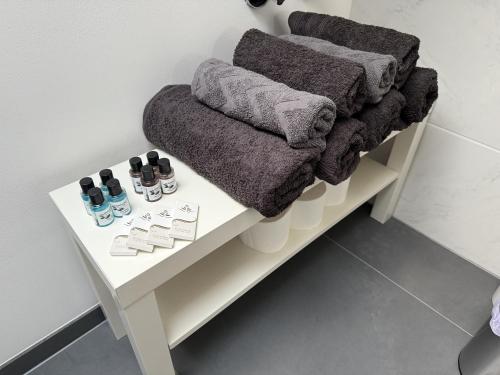 a white table with towels and shoes on it at Studio Eleven - Loft mit Kicker in Schrobenhausen