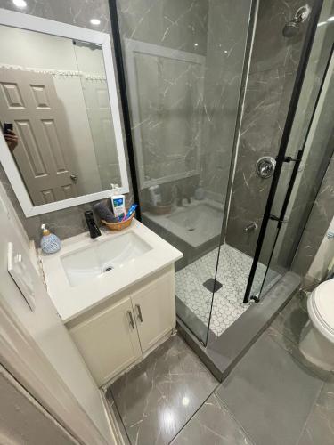 a bathroom with a sink and a shower at Central Downtown New Year Stay- Self Checkin & Free Wifi in Toronto