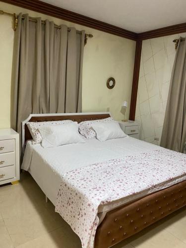 a bedroom with a large bed with white sheets and pillows at Constanza Family House in Constanza