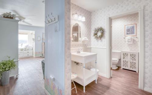 a bathroom with a sink and a toilet at Coastal Garden - Anchor Pier Lodge in Newport