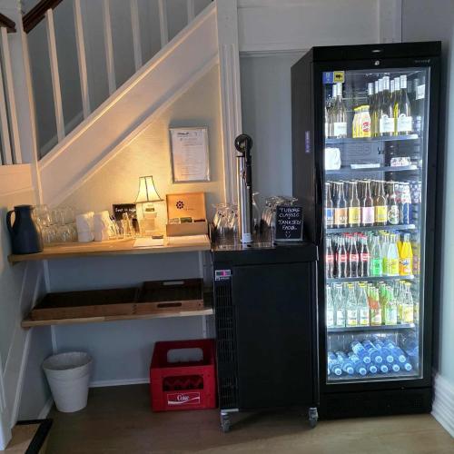a refrigerator filled with lots of bottles of soda at Hotel Udsigten Marstal in Marstal