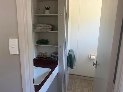 a bathroom with a sink and a white cabinet at Lumsden Motel in Lumsden
