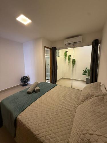 ein Schlafzimmer mit einem großen Bett und einer Dusche in der Unterkunft RM Hospedage Unidade Amapa 2 in Cabo Frio