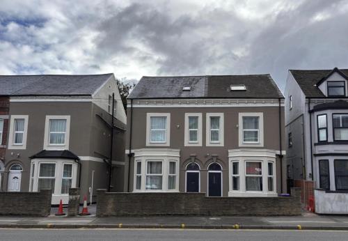 a group of three houses on a street at Nottingham Forest The City Ground Studio Apartments in Nottingham