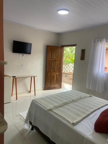 Ένα ή περισσότερα κρεβάτια σε δωμάτιο στο Sabiá & C0 Casa Hotel Suítes