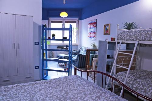 a dorm room with bunk beds and a staircase at Il Cortiletto in Susa