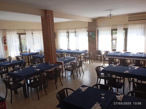 a dining room with blue tables and chairs at Hostal prados abiertos in La Parra