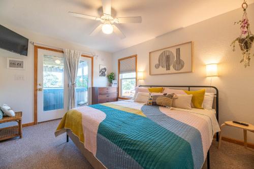 a bedroom with a bed and a ceiling fan at D3943 The Pup Deck - Oceanside, Pool, Hot Tub, Pets OK, Beach & Sound Access! in North Point