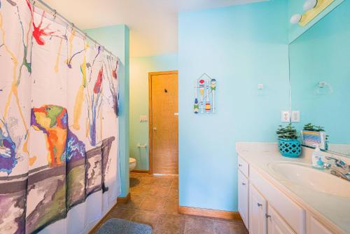 a bathroom with a sink and a shower curtain at D3943 The Pup Deck - Oceanside, Pool, Hot Tub, Pets OK, Beach & Sound Access! in North Point