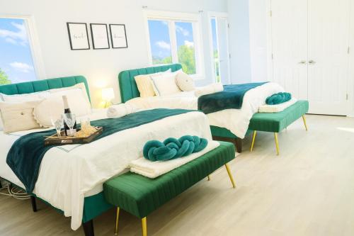 two beds in a room with blue and white at Modern Lakeview Escape | Scenic Deck • Fire Pit in Monroe