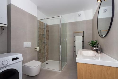 a bathroom with a shower and a toilet and a sink at Apartmani Ljubica in Duće