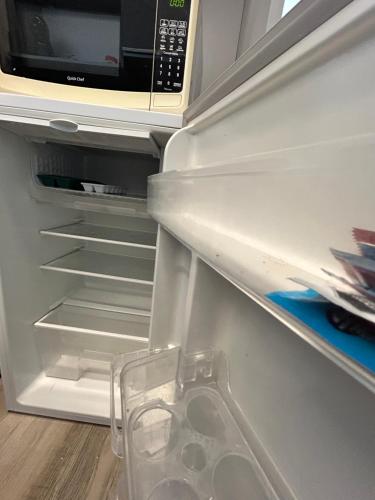 a refrigerator with its door open with a microwave at Rent Montañeses Nuñez in Buenos Aires