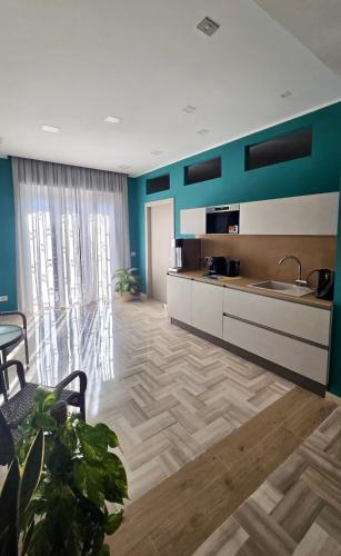 a room with a kitchen with a sink and a table at Da Delfina Affittacamere in Anzio