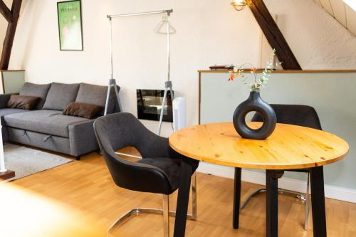 a living room with a table with a vase on it at Bremen-Weyhe - peaceful - kitchen - wifi in Weyhe