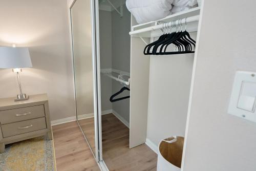 a closet with a mirror and a table and a lamp at Urban retreat- Quiet comfy 1 bedroom condo near LAX in Los Angeles