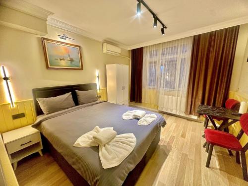 En eller flere senge i et værelse på Taksim Vista Apart