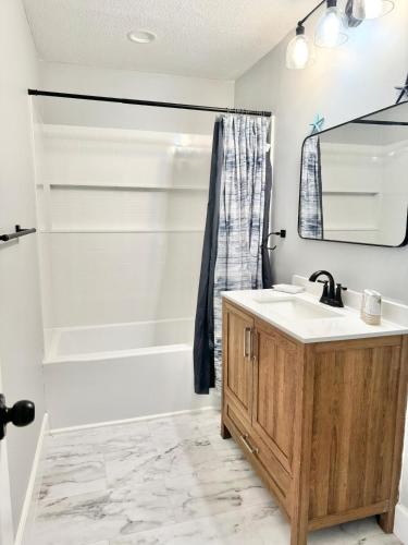 a bathroom with a sink and a bath tub at Modern cozy Home Palm Coast in Palm Coast